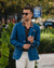 Man wearing a blue blazer and sunglasses outdoors