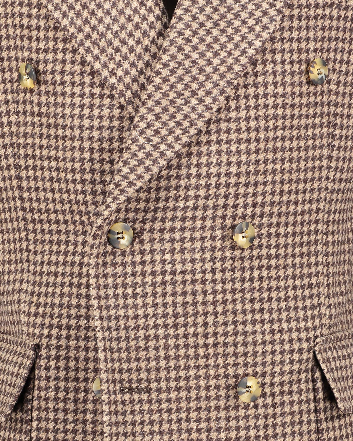 Close-up of a brown houndstooth patterned double breasted overcoat with tortoise buttons.