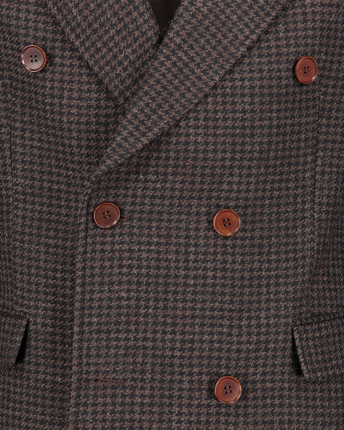 Close-up of a brown double breasted houndstooth patterned coat with buttons.