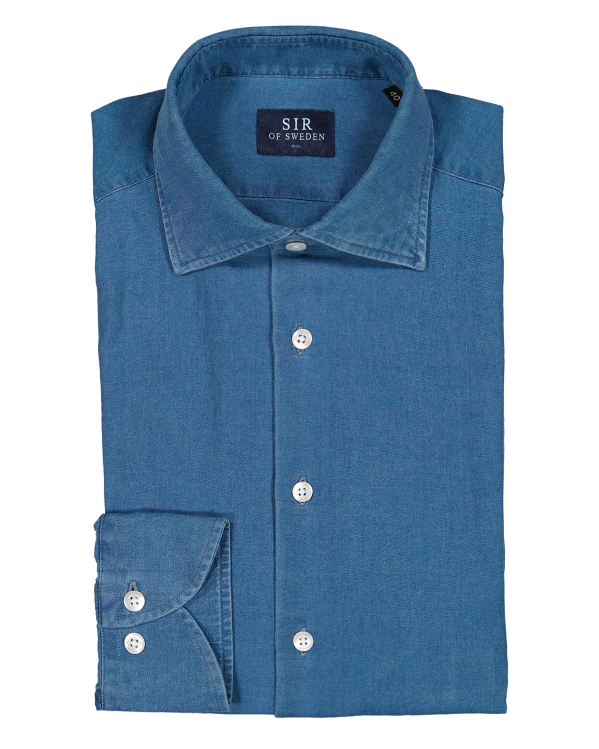 Folded blue denim shirt with 'SIR of Sweden' label on a white background