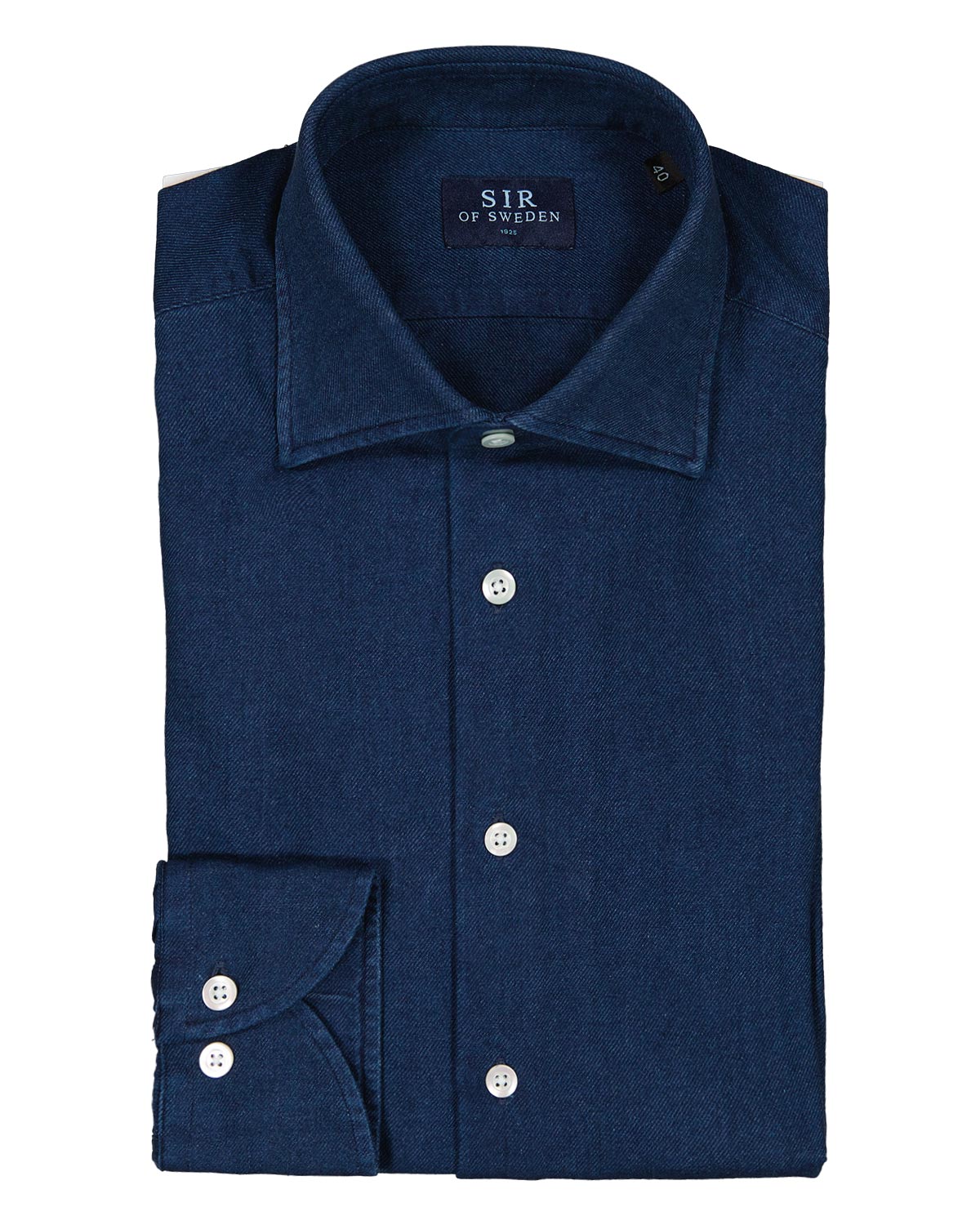 Folded navy blue denim shirt with visible brand logo on a white background