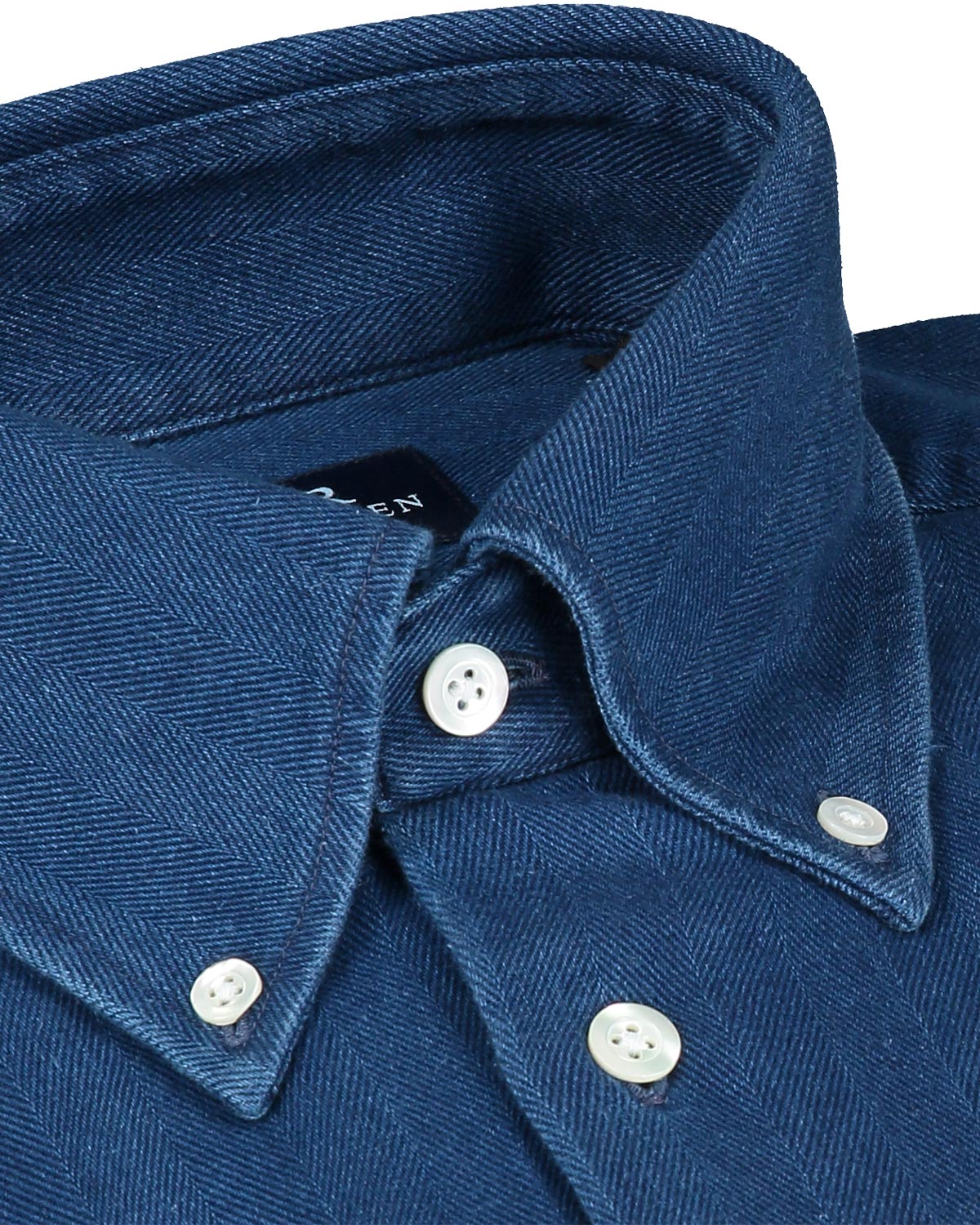 Close-up of a blue denim shirt collar with buttons on a white background