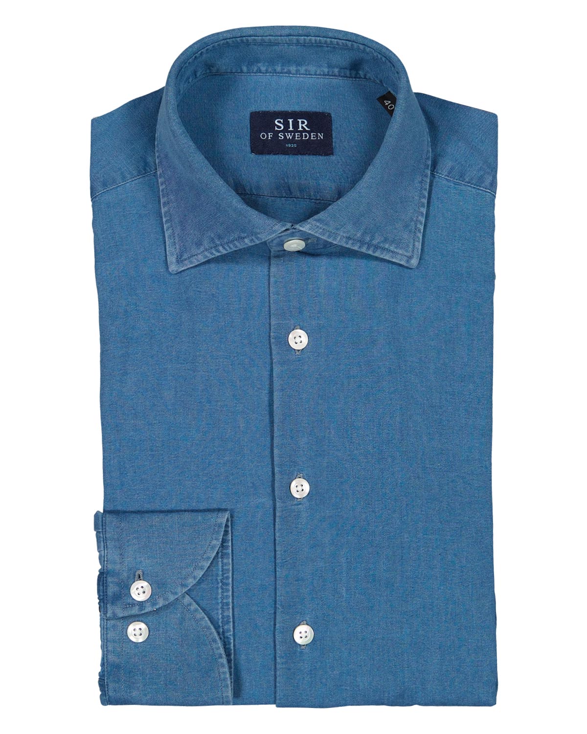 Folded blue denim shirt with 'SIR of Sweden' label on a white background