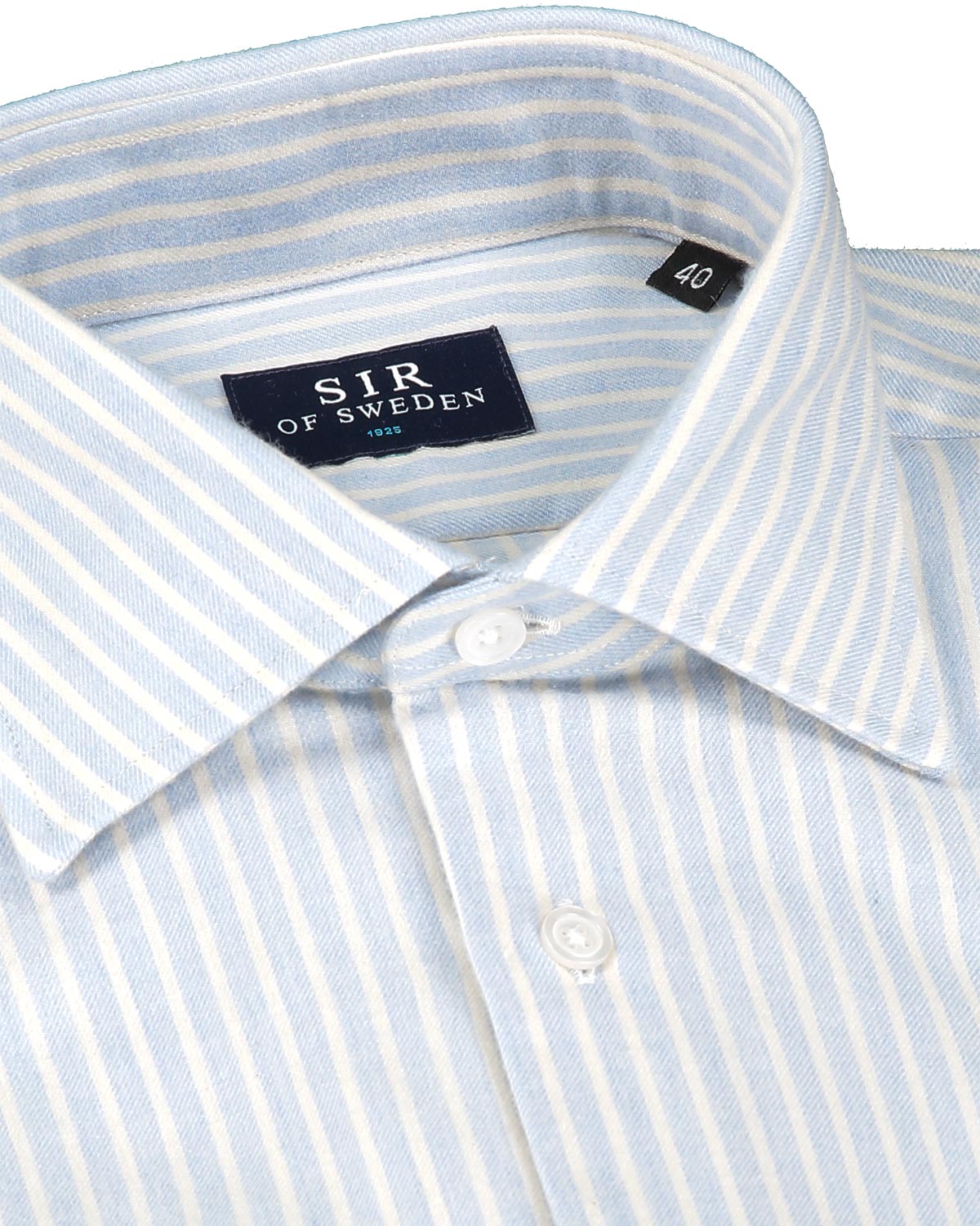 Close-up of a light blue and white striped flannel shirt with 'SIR OF SWEDEN' label.