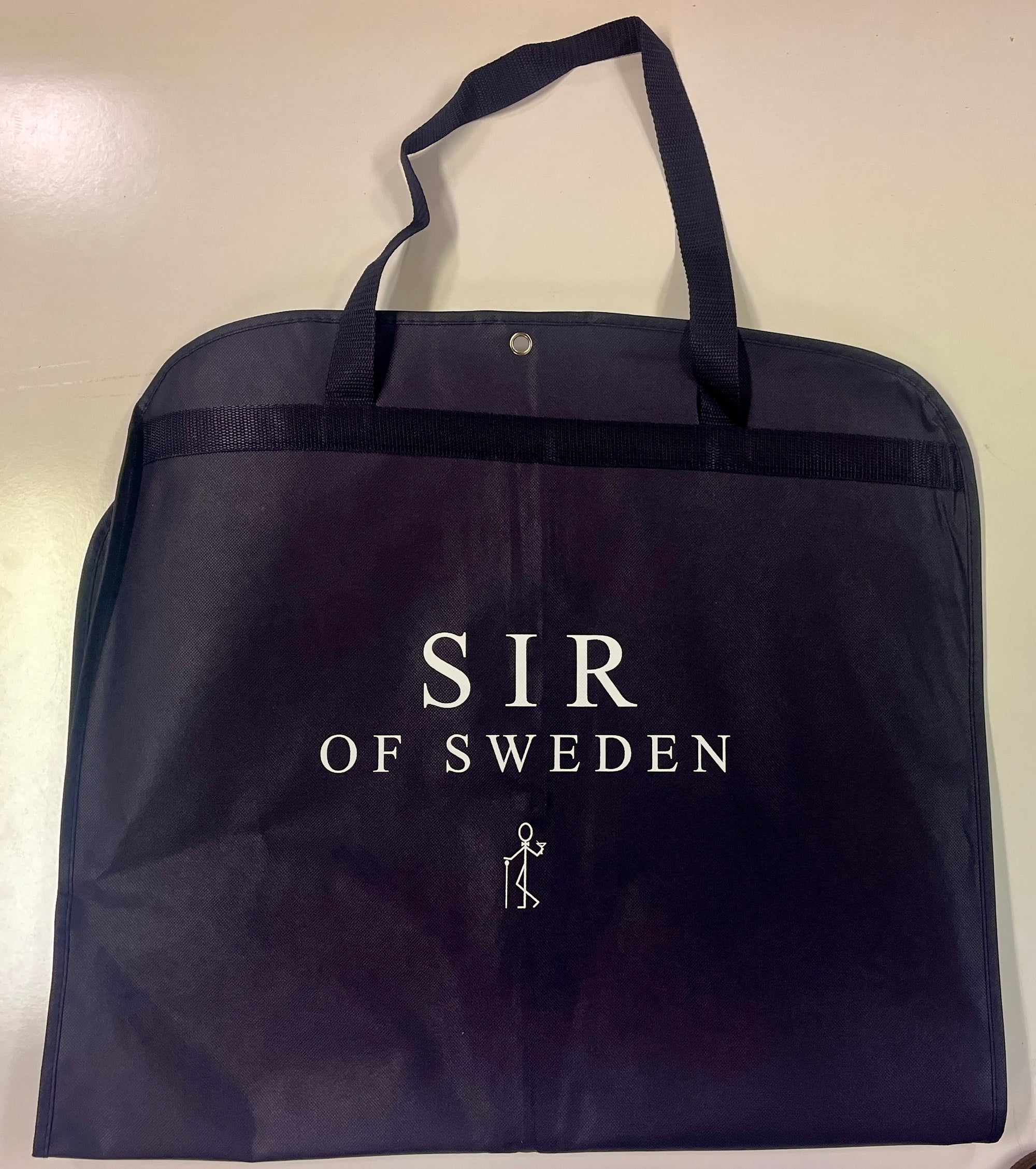 Navy blue garment bag with 'SIR OF SWEDEN' branding on a light background