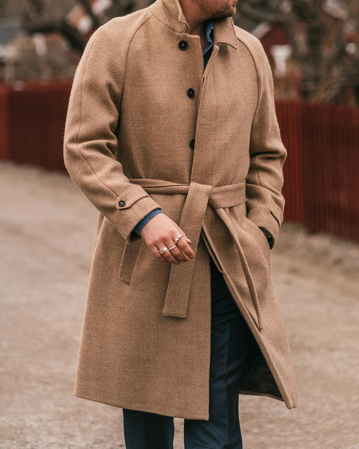 Person wearing a beige coat with a blurred background